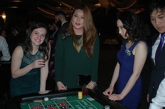 Women having fun at a roulette table party in Baltimore